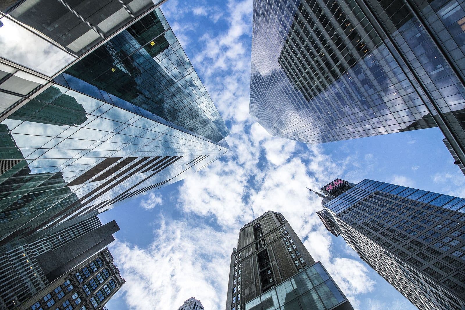 Corporate office towers rising overhead in a financial district